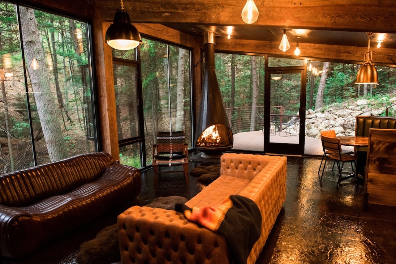 The Ledge
Hocking Hills, Ohio
From $465/night | Hosts 6 guests
“The Ledge@LostCavern blends sleek and modern design with old-world appeal. Perched on the bank of a 50’ cavern this six guest, Midcentury mod cabin features salvaged timbers and a Malm fireplace. The warm lighting and radiant heated floors invite you in for hygge time with friends and family, while the floor to ceiling windows draw you outwards.” — Vrbo