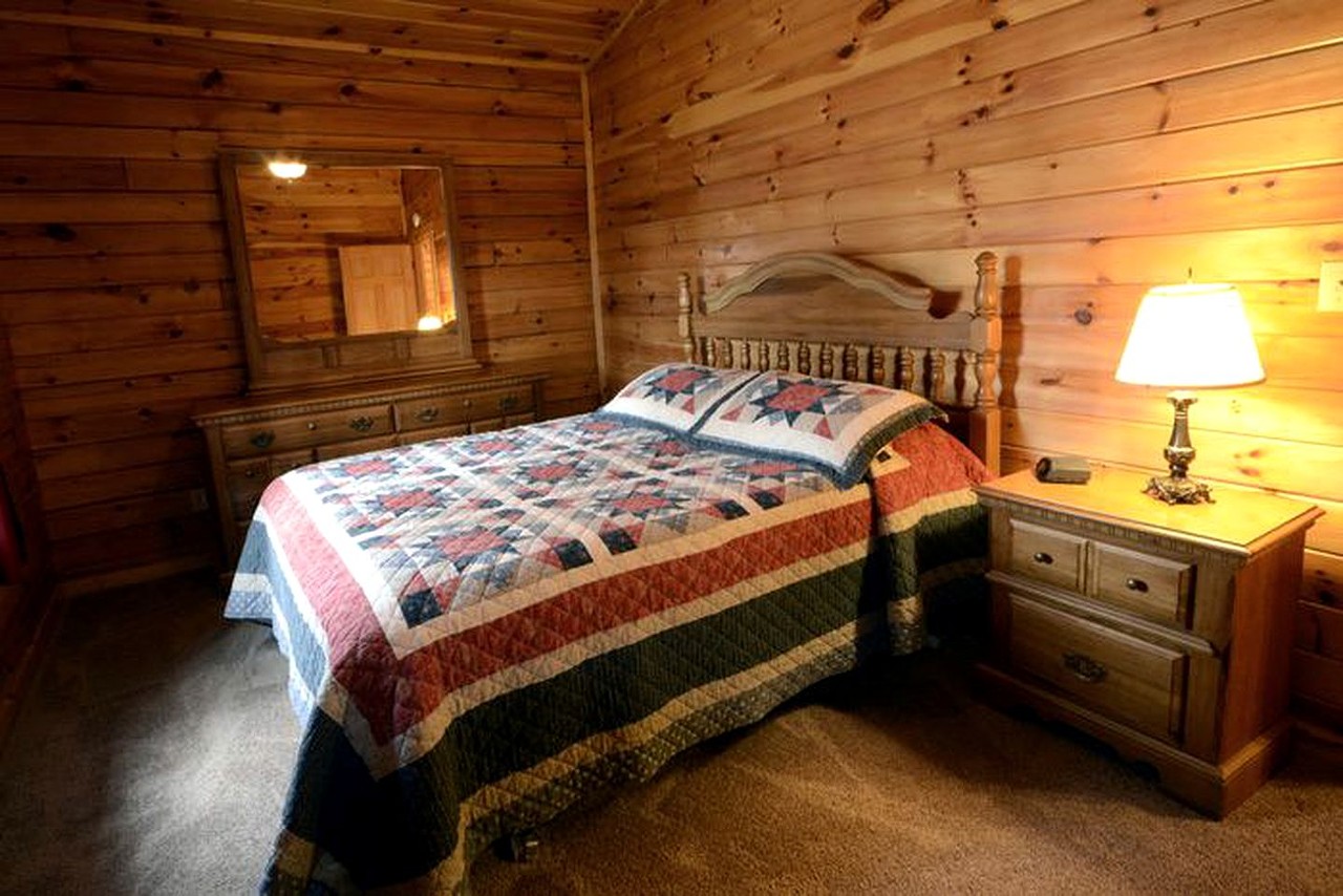  Charming Log Cabin
Logan, Ohio
Price upon request | Hosts 8 guests
“A luxuriously rustic vacation awaits at this charming log cabin in the woods near Lake Logan in Ohio. With three spacious bedrooms and two bathrooms, this cabin comfortably accommodates up to eight guests. The master bedroom on the main floor has a queen-size bed and a full private bathroom. It also has a large mirror at the vanity table and a matching wooden nightstand. The other two bedrooms share a bathroom on the lower level and both have queen-size beds and matching furniture. There is also a queen-size log futon on the lower level. All linens and towels are provided. This cabin is ideal for every season with central air conditioning and heating, plus a seasonal indoor fireplace.” — GlampingHub