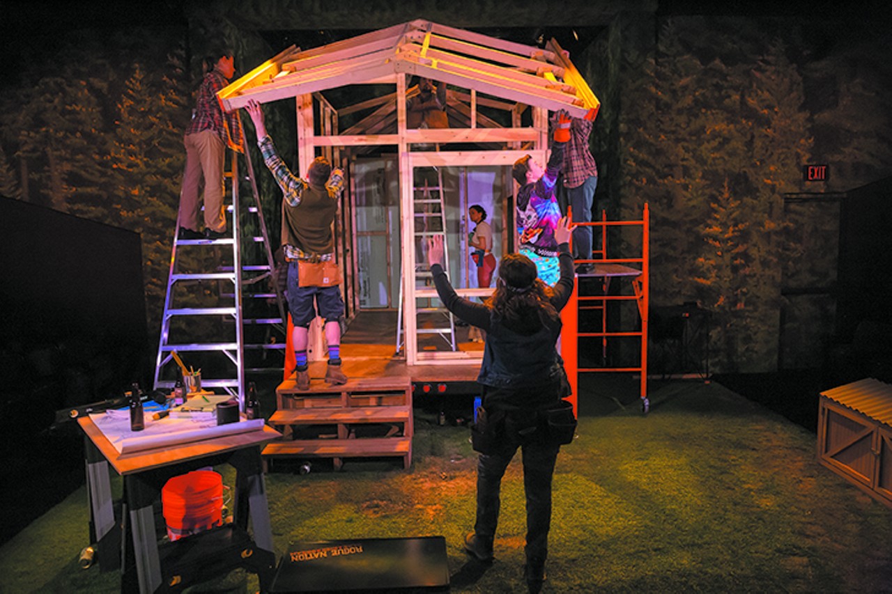 FRIDAY 17
ONSTAGE: Tiny Houses
There&#146;s a kind of time warp going on with the Cincinnati Playhouse&#146;s world premiere production of Chelsea Marcantel&#146;s Tiny Houses. At the outset, Bohdi (Peter Hargrave), the optimistic half of a couple who recently relocated from New York City to northern Oregon, is enthusiastically convinced that he can complete the construction of a 200-square-foot house in three months, maybe four. His girlfriend of four months, Cath (Kate Eastman), a banker who has abandoned employment but is financing the project, is more pragmatic and dubious. Help of questionable value comes from two of Bohdi&#146;s past acquaintances. Ollie (Michael Doherty) is hosting the project in his backyard since Bohdi has not yet purchased the necessary land; the plan is to trailer the house into the woods when (or if) it&#146;s completed. Jevne (Nandita Shenoy), a loony girlfriend from Bohdi&#146;s Oregon past, turns up to help, full of second guesses about construction and clearly wangling for Bohdi&#146;s affections.Director Laura Kepley, the artistic director at the Cleveland Play House &#151; the show is a co-production with that Northeast Ohio theater &#151; has highlighted the humor in Marcantel&#146;s script by using spotlighted monologues for each actor to show off his or her comic chops. This gives us deeper insights into their characters&#146; offbeat personal psyches. They&#146;re self-absorbed in ways you might recognize, and that&#146;s the fun of this show, even if the message is kind of muddy. The confines of a tiny house pressurize the play&#146;s entertainment quotient, even if these characters are more caricatures. Tiny Houses is like watching exotic animals in a crazy zoo. Tiny Houses, presented by the Cincinnati Playhouse in the Park, continues through June 2. More info/tickets: cincyplay.com.
Photo: Mikki Schaffner Photography