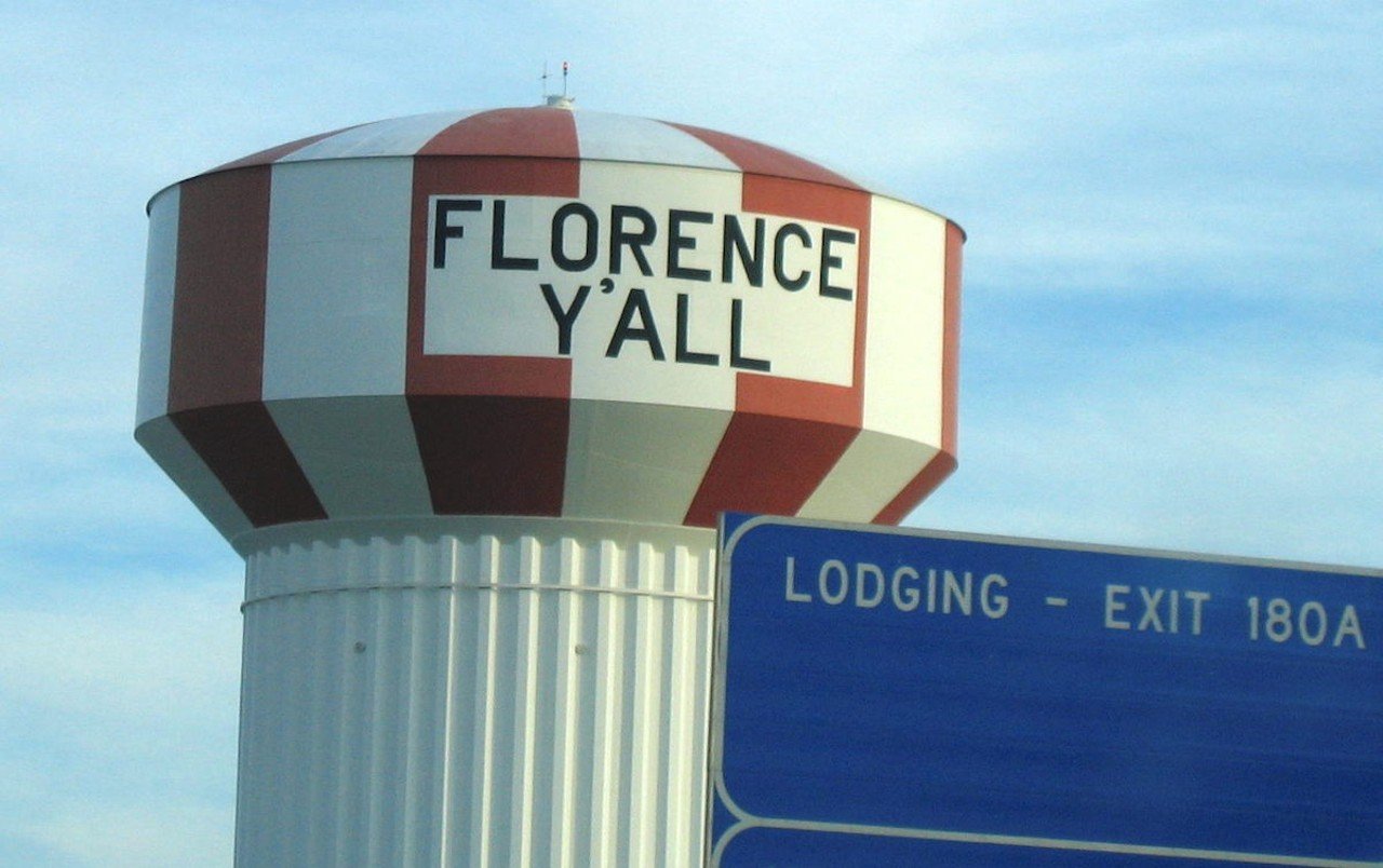 The Florence Y’all Water Tower
She’s big and looks slightly like a candy cane, what’s not to love? And how she got her name is a great local tale: The water tower was originally painted to say “Florence Mall” (and to this day is still used to remind you what exit to take to get to said mall), but because it was finished before the actual mall, Florence was told they couldn’t use the water tower to advertise something not actually there. Repainting the whole thing would be too expensive, so the Kentucky city drew on its good, ole Southern hospitality and replaced the “M” with a greeting for everyone driving down I-71/75.