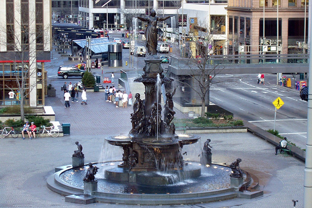 The Genius of Water
520 Vine St., Downtown
In the heart of Fountain Square stands the 43-foot tall bronze-cast Genius of Water fountain, also known as the Tyler Davidson Fountain. Cincinnati businessman Henry Probasco commissioned German artists August von Kreling and Ferdinand von Miller for a fountain design as an ode to Tyler Davidson, his brother-in-law and business partner who had passed away. Since its presentation to the city in 1871, the Genius of Water fountain is a remarkable work of art fit for being recognizable as the heart of the city. The fountain honors and depicts the use of water as a necessity of life through the actions of the bronze figures surrounding the fountain; children fishing, workmen praying for water to stop a burning fire, farmers praying for water through a drought are all scenes told through the fountains endless detail. Fun fact: The four figures around the edge produce drinkable water.
Photo: Derek Jensen