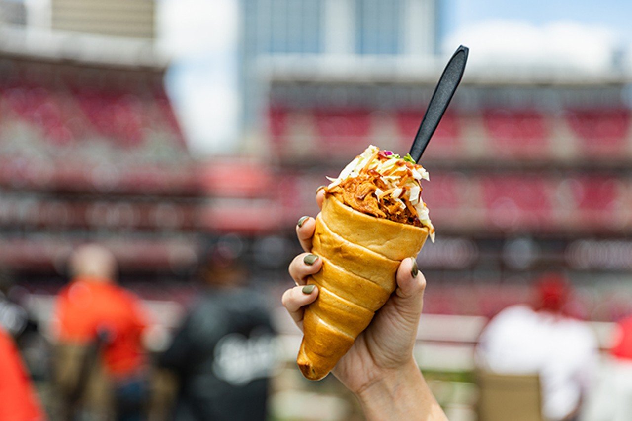 Catch a Reds Game and Chow Down on a Smokehouse Parfait
100 Joe Nuxhall Way, The Banks
With its leisurely pace, foam-fingered cheers and Hammond organ interludes, baseball is the quintessential summer sport. But honestly? Sometimes we just want the food.
Ballpark fare can make anyone salivate. The mouth-watering nostalgia of ice cream in miniature batter&#146;s helmets. The tantalizing siren call of tangy relish on a foot-long hot dog. And those are all great. But we really want the good stuff. The weird stuff. The Smokehouse Parfait at the Great American Ball Park scratches that itch. New for 2021, the item is exactly what you&#146;d imagine: barbecue pulled pork, mac and cheese and coleslaw, all loaded up into a squishy bread cone. Find it behind section 137 of the GABP at Mr. Red's Smokehouse presented by Montgomery Inn.
Photo: Hailey Bollinger