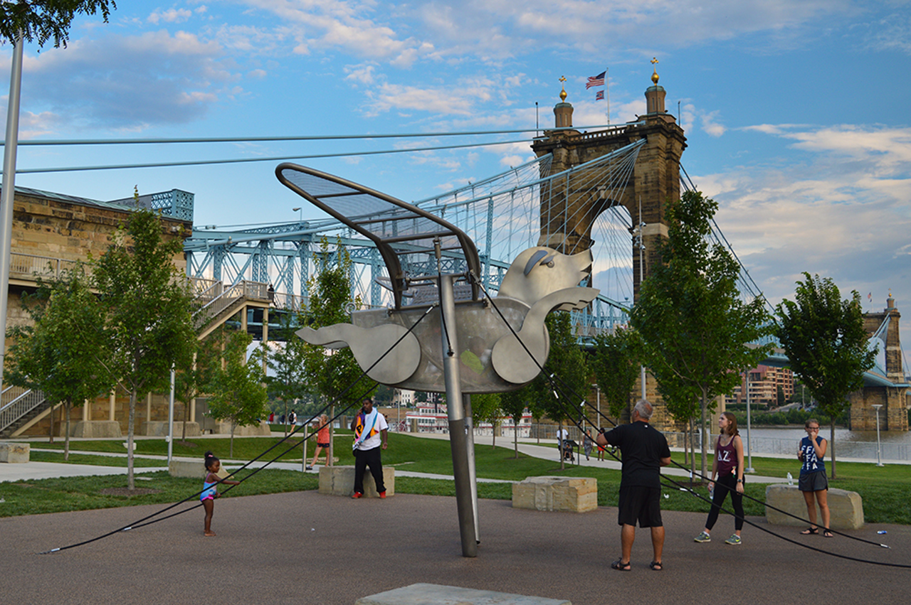 Take in the View at Smale Riverfront Park
166 W. Mehring Way, The Banks
You can’t be a Cincinnati tourist if you don’t stop to look at one of our most iconic landmarks: the John A. Roebling Suspension Bridge. While it’s true the best view of the bridge is from Covington with Cincinnati’s skyline in the background, Smale Riverfront Park offers stunning views of the bridge, plus a whole lot more. Recently voted one of the top five riverwalks in the country in USA Today’s 10Best, Smale connects downtown from Paul Brown Stadium to Great American Ball Park with 45 acres of greenway. The park features public art, interactive fountains, playgrounds and giant swing sets that give a hell of a view of the Ohio River. Not only that, but you can walk or bike the paved trail from Smale through Sawyer Point, Yeatman’s Cove and down to Montgomery Inn and Friendship Park, or over the Purple People Bridge into Newport, all without getting near a car. And at Smale, you’re near all the fun The Banks has to offer, like the Andrew J Brady Music Center, Carol Ann’s Carousel, The Banks’ DORA (designated outdoor refreshment area) and quality Cincinnati establishments like Moerlein Lager House, E+O Kitchen and The Filson.