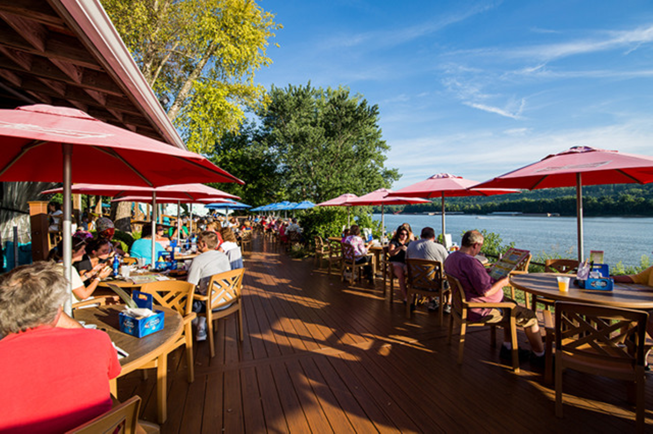 Cabana on the River
7445 Forbes Road, Sayler Park
This Margaritaville-esque oasis on the river will make you feel like you’re on vacation with their neon palm trees out front, sand volleyball courts, multiple walk-up bars where you can snag a drink while you wait for a table and just overall Jimmy Buffett vibes. While all the seating is technically outside, the best seats aren’t underneath the awning, but on the lower deck closest to the river. The menu is similar to what you’d find at a beachy restaurant – fish tacos, burgers, chicken sandwiches and shareables – but they also have some great salad options as well as the Cincinnati touch of metts, brats and franks. We also highly recommend a margarita while you’re there to 1) complete the aesthetic and 2) because they’re delicious. Cabana on the River officially opens for the season on April 15.