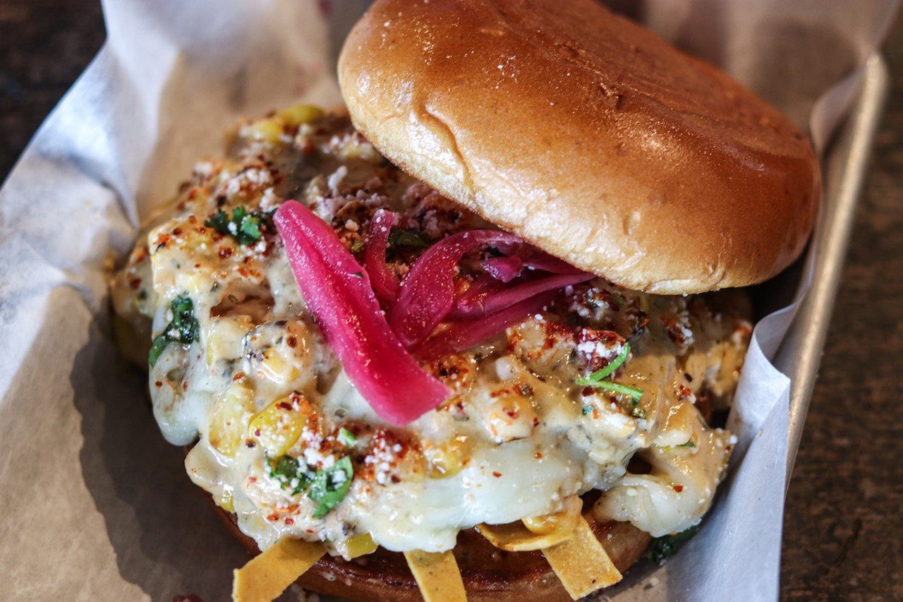 16 Lots Southern Outpost
1 Levee Way, Newport
Elote Burger: An Angus beef patty with Mexican street corn dip, pickled red onion, cilantro, cotija, tajín and jalapeño chipotle aioli on a brioche bun.