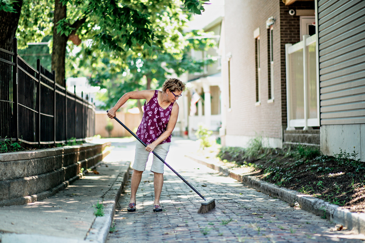 Recent Northside arrival Kelly Johnson sweeps Pope Alley, adjacent to her home.