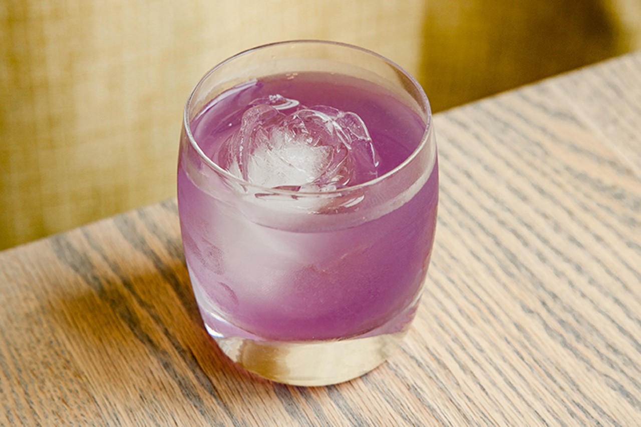 The She-Wolf, with Old Tom Gin and pear, ginger and elderflower liqueurs. It is a vivid purple color and comes served in a tumbler with a rose-shaped ice cube.