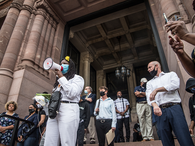 Iris Roley of the Black United Front speaks on the steps of Cincinnati City Hall