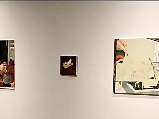 The alleged Banksy painting (center) at the Contemporary Arts Center, hanging among works from "Mamma Andersson: Memory Banks."