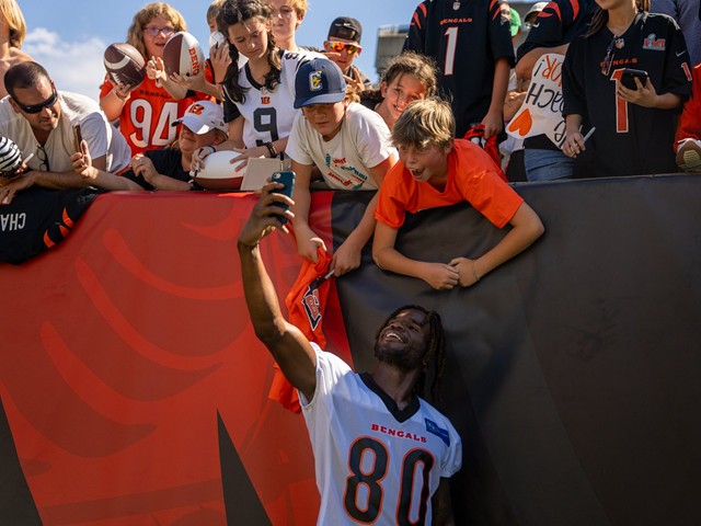 Bengals wide receiver Mike Thomas taking a selfie with a fan.