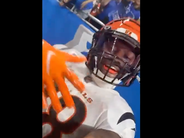 The Bengals' Joe Mixon takes a video selfie with fan Sebastian Day's phone on Oct. 17, 2021.