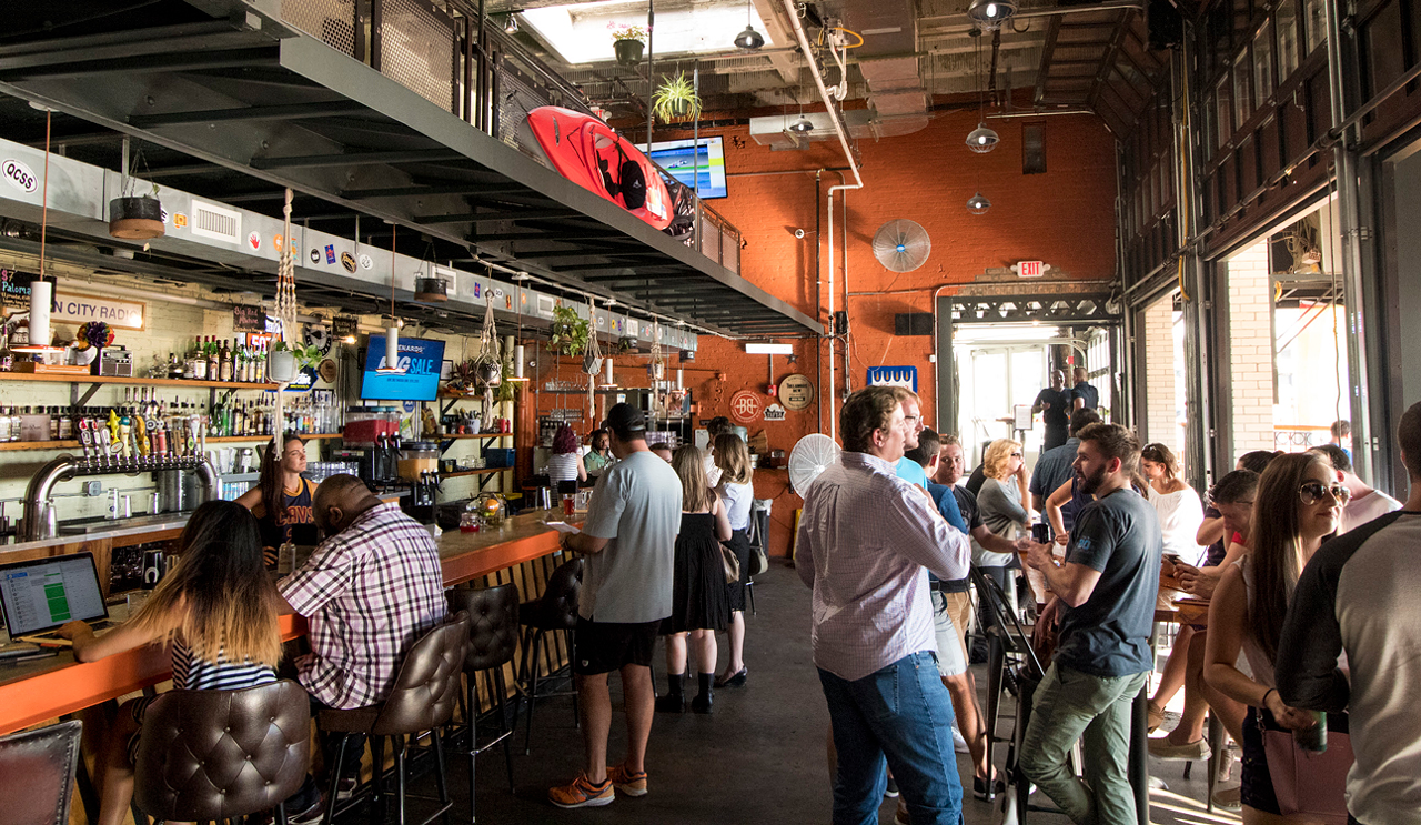 Garage doors create indoor/outdoor space, weather permitting, and the patio boasts not only a ton of seating, but the on-site Queen City Whip food truck (which serves burgers, shakes, and chili fries) and a new outdoor bar in a converted Airstream trailer.