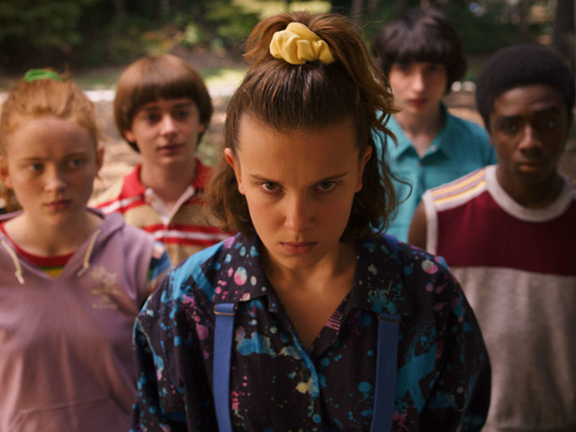 Millie Bobby Brown (front) as Eleven in "Stranger Things" with fellow cast members.