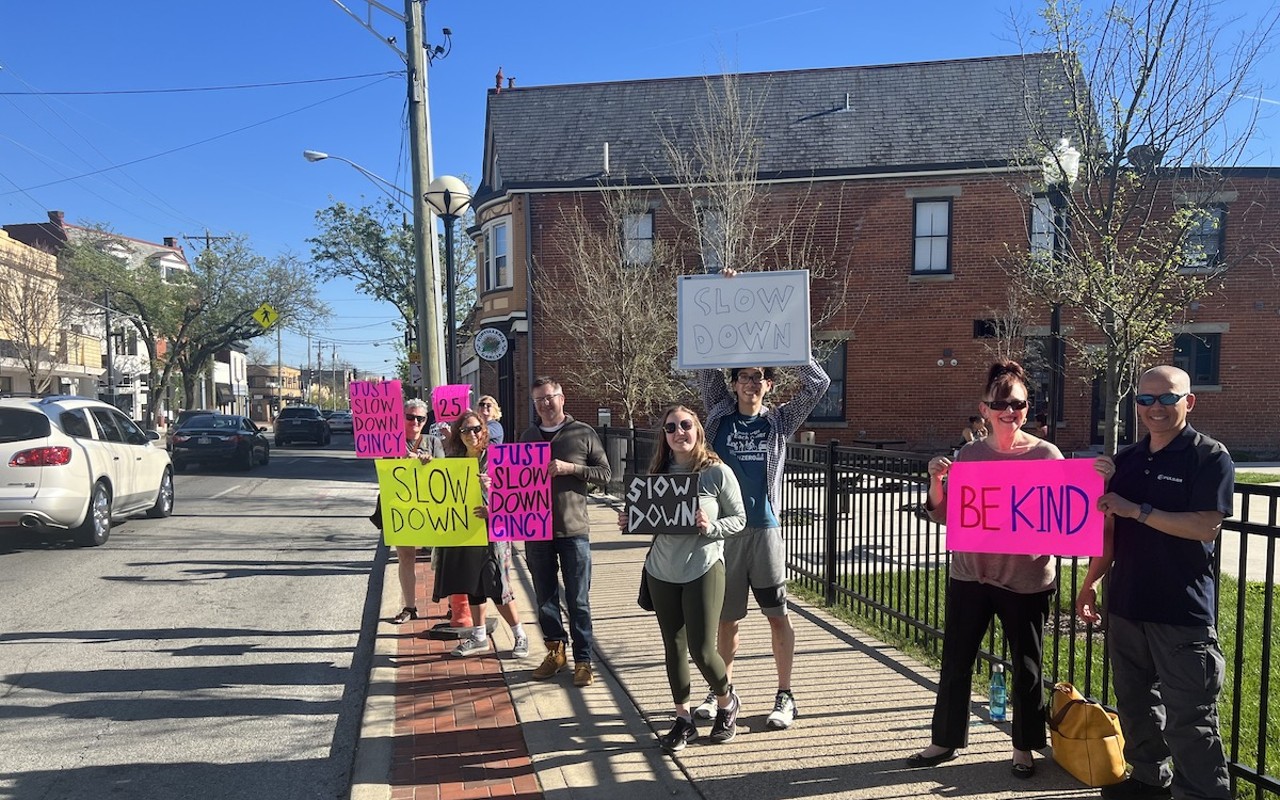 A group of volunteers on April 12 encourage drivers on Hamilton Avenue to slow down.