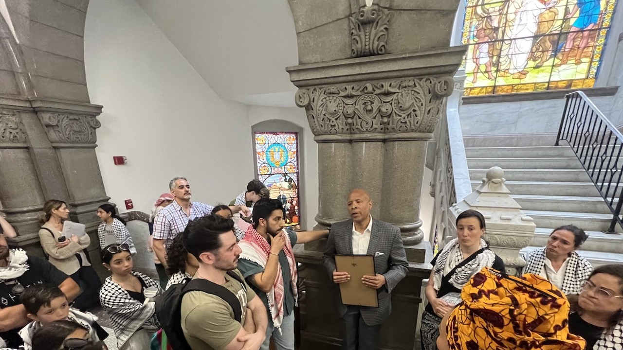 Cincinnati City Council member Scotty Johnson talks with pro-Palestinian gallery members after a World Keffiyeh Day resolution was passed with a controversial amendment.