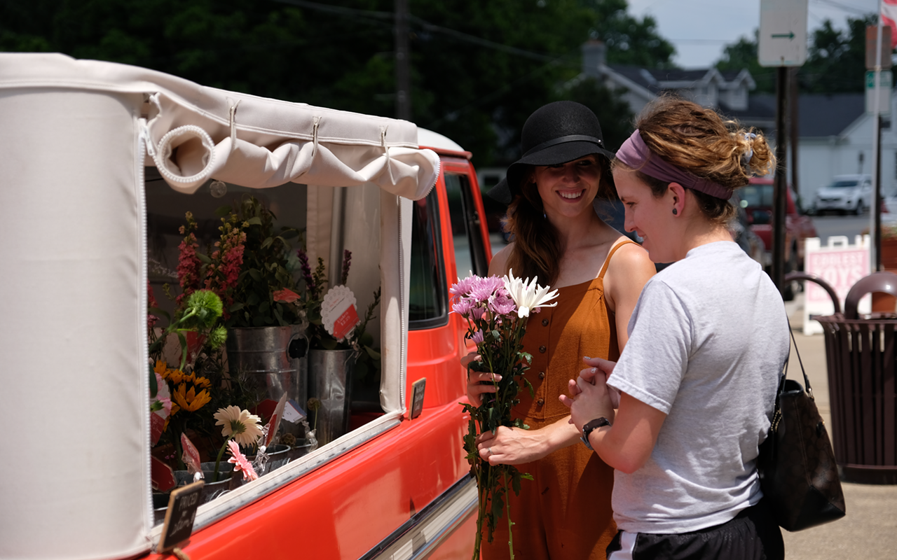 Megan Moore helping a customer arrange a bouquet.