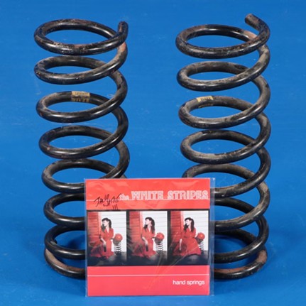 Jack White Signed "Hand Springs" Vinyl with Cover Art Prop Springs
"These thick gauge springs were discovered in Detroit by Jack White in the 1990s. Likely found in the garbage or an abandoned building, they were on display in White’s Southwest Detroit home for years, a theoretical art/design piece. Upon the release of the White Stripes song “Hand Springs” in the March 2000 issue of Multiball magazine, the cover image to the single depicts Meg White sitting next to one of these springs with a bowling ball placed upon it. An iconic piece of White Stripes cover art prop OR…if you just need to replace the shocks on your 1986 Trabant, these suckers will get the job done wonderfully. Springs come paired with a 2012 copy of the “Hand Springs” single autographed by Jack White."