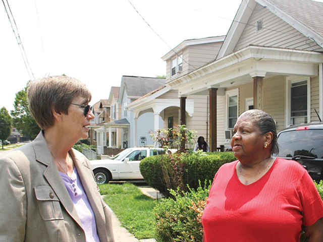 Sister Barbara Busch of Working in Neighborhoods (left) discusses houses the group has renovated in South Cumminsville with Marilyn Evans of Communities United for Action.