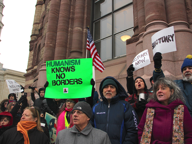 Rally attendees outside Cincinnati City Hall protest President Donald Trump's immigration ban Jan. 30.