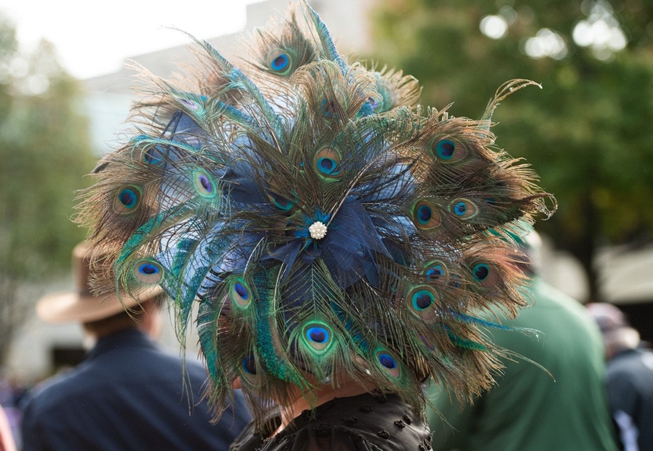 Avondale
Peacock feathers are often a symbol of wild, natural beauty. And thanks to the Cincinnati Zoo & Botanical Garden in Avondale, many Cincinnatians and visitors get to see and explore that natural beauty up close without having to leave the city. Circled with peacock feathers, his fascinator reminds us of the fascinating world the zoo opens us up to.