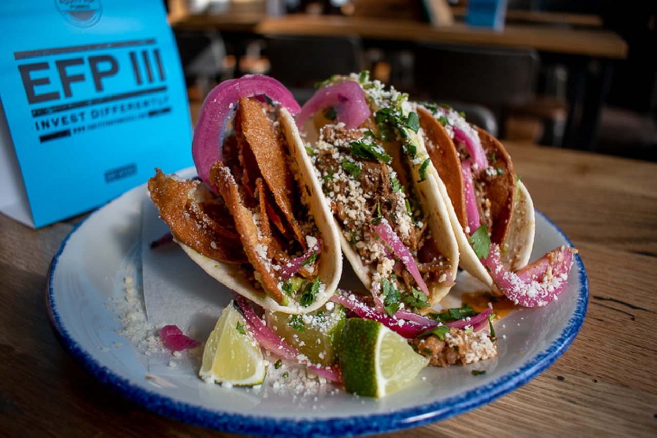 The carnitas tacos features pork with pickled onion, avocado, cilantro and Cotija cheese.