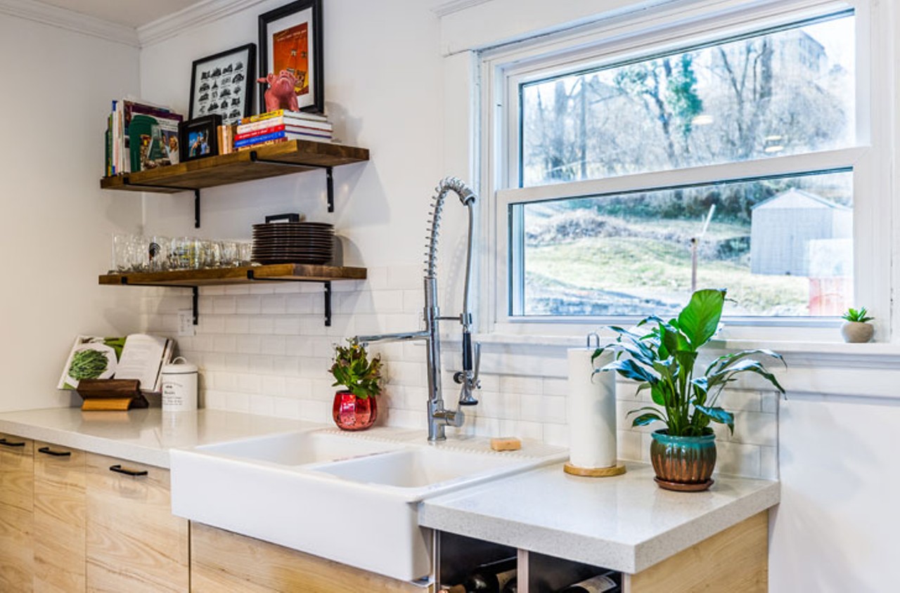"The sink is also from IKEA. ?We got an awesome deal on the faucet at Bargains & Buyouts ?in Western Hills.? ?We built the shelves using ?butcher block boards that we cut and stained, and placed on top of ?handmade brackets ?from a seller on Etsy?. The cookbook holder was a handmade gift from Uncle Joe.?" &#151; Chris?