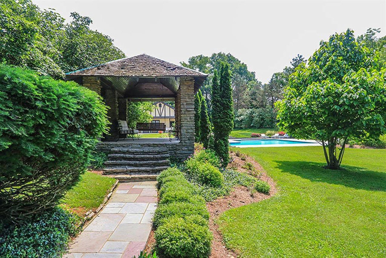 7325 Indian Hill Road, Indian Hill
$2,299,000 | 5 bd/8 ba | 9,496 sq. ft. | Year Built: 1923
This massive estate is situated on over five acres of land in Indian Hill. The home features arched doorways and beamed ceilings with unique details throughout the space. The park-like backyard offers a spacious, private pool, tennis court and breathtaking views.