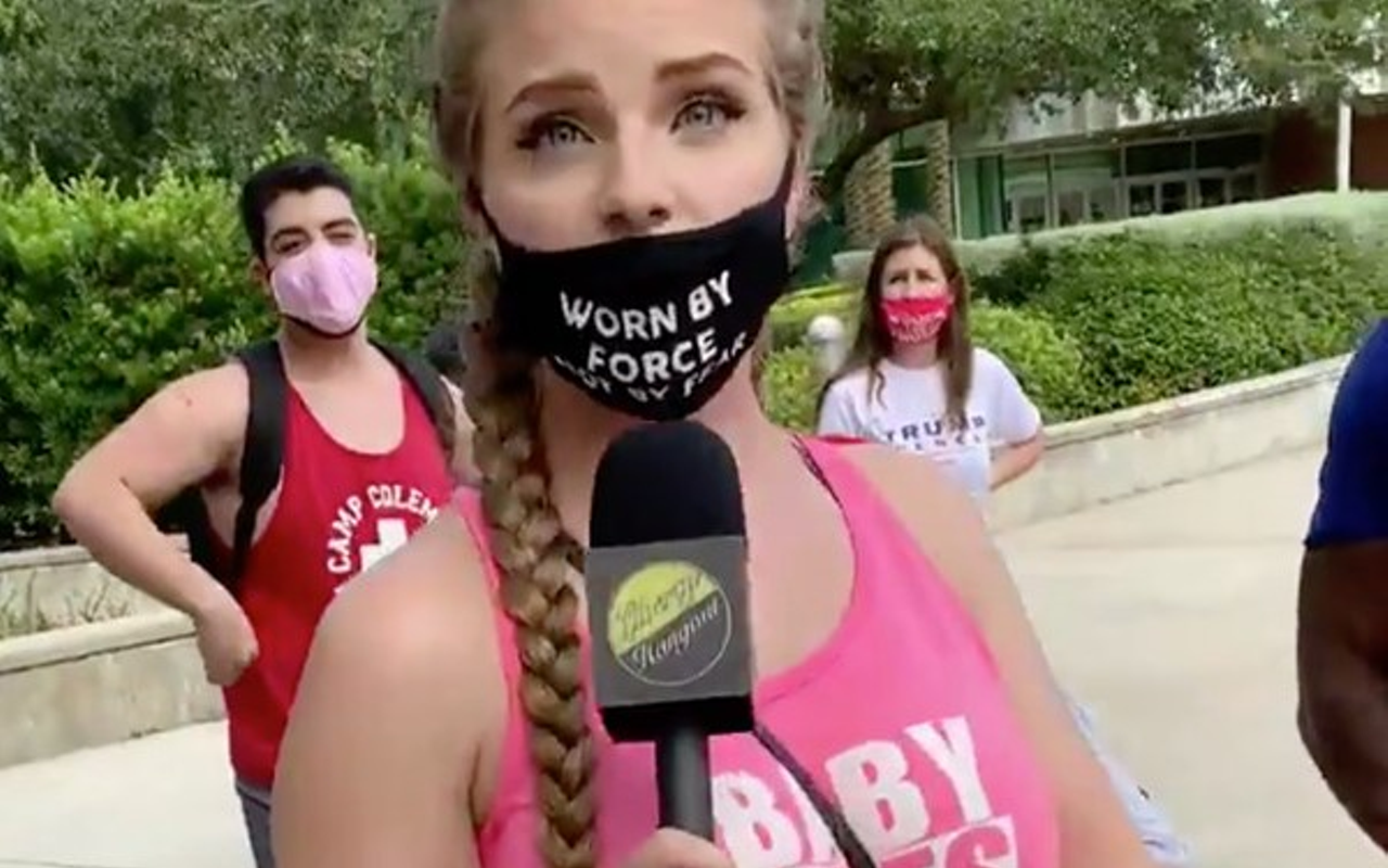 Kaitlin Marie Bennett in a pink tank top that says "Baby Lives Matter" and a mask that says "Worn by force not by fear."