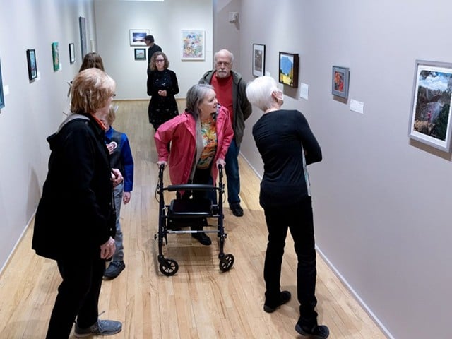 Viewers take in the art at a previous Accessible Arts exhibit.