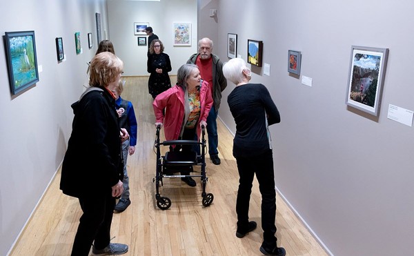 Viewers take in the art at a previous Accessible Arts exhibit.