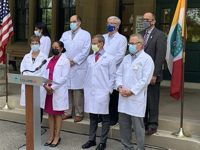 Columbus Public Health Commissioner Dr. Mysheika Roberts, flanked by physicians and health officials, speaks in front of the Franklin County Public Health building on Aug. 5, 2021.