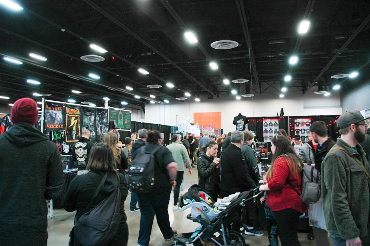 Convention attendees bustle among the various booths selling all kinds of horror-related ephemera.