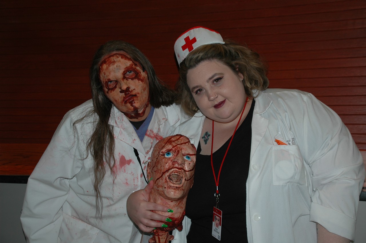 Two costumed attendees “play doctor” in ghoulish attire