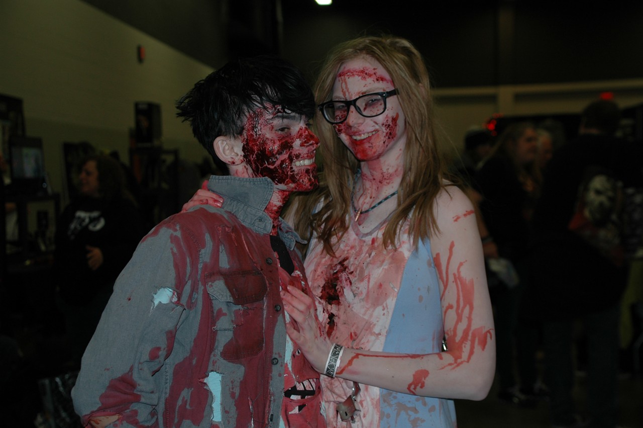 After being seemingly eaten by zombies, two attendees embrace