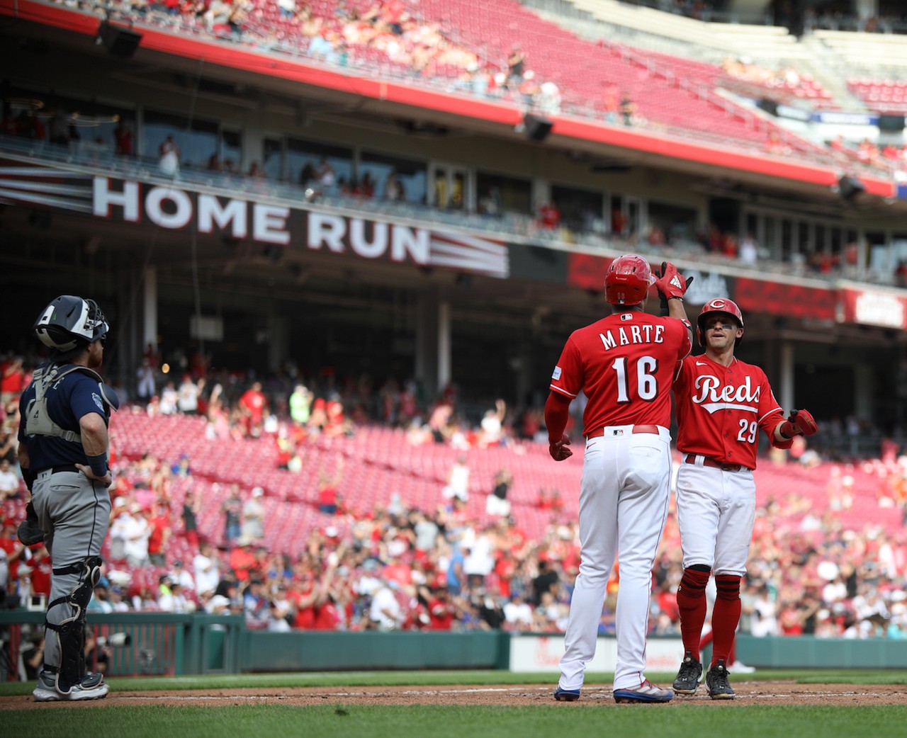 Noelvi Marte and TJ Friedl score off Spencer Steer's homerun in the bottom of the second inning during the Cincinnati Reds' game against the Seattle Mariners on Sept. 4, 2023.
