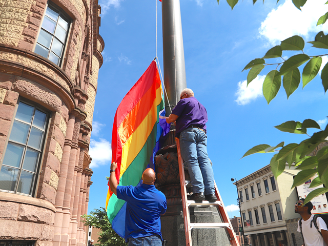 City workers raise the pride flag outside of Cincinnati City Hall. The Queen City is one of about two dozen throughout Ohio with its own municipal anti-discrimination laws for sexual orientation. The state doesn't have those laws — yet.