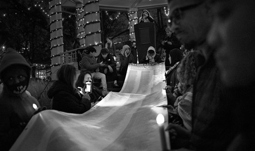 Attendees of the Peace Vigil for Gaza event at Washington Park on Dec. 17 hold a large scroll with the names of the Palestinians killed in Gaza since Oct. 7.