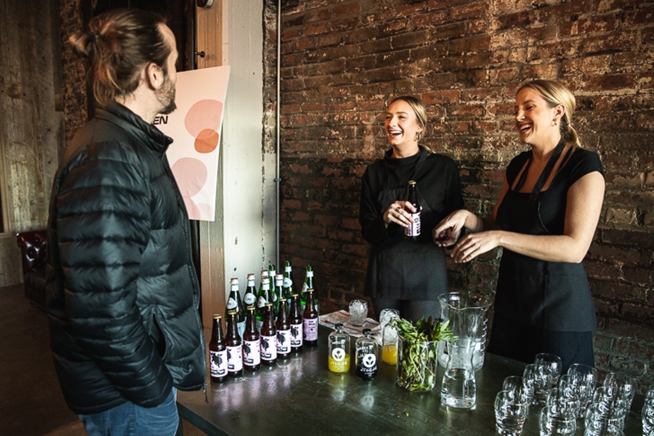 Guests arriving at tasting event and ordering palate cleansing beverage.