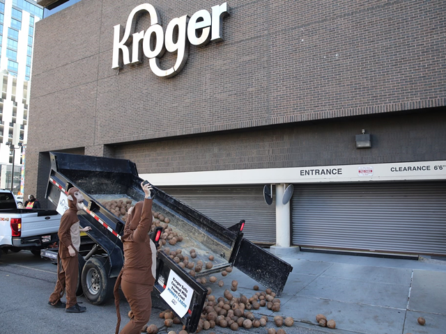 PETA supporters dropping humanely picked coconuts in front of Kroger's downtown HQ last month to protest their involvement with coconut milk brands that use monkey slave labor
