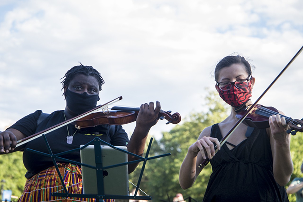 Musicians play during a vigil for Elijah McClain July 12 in Washington Park