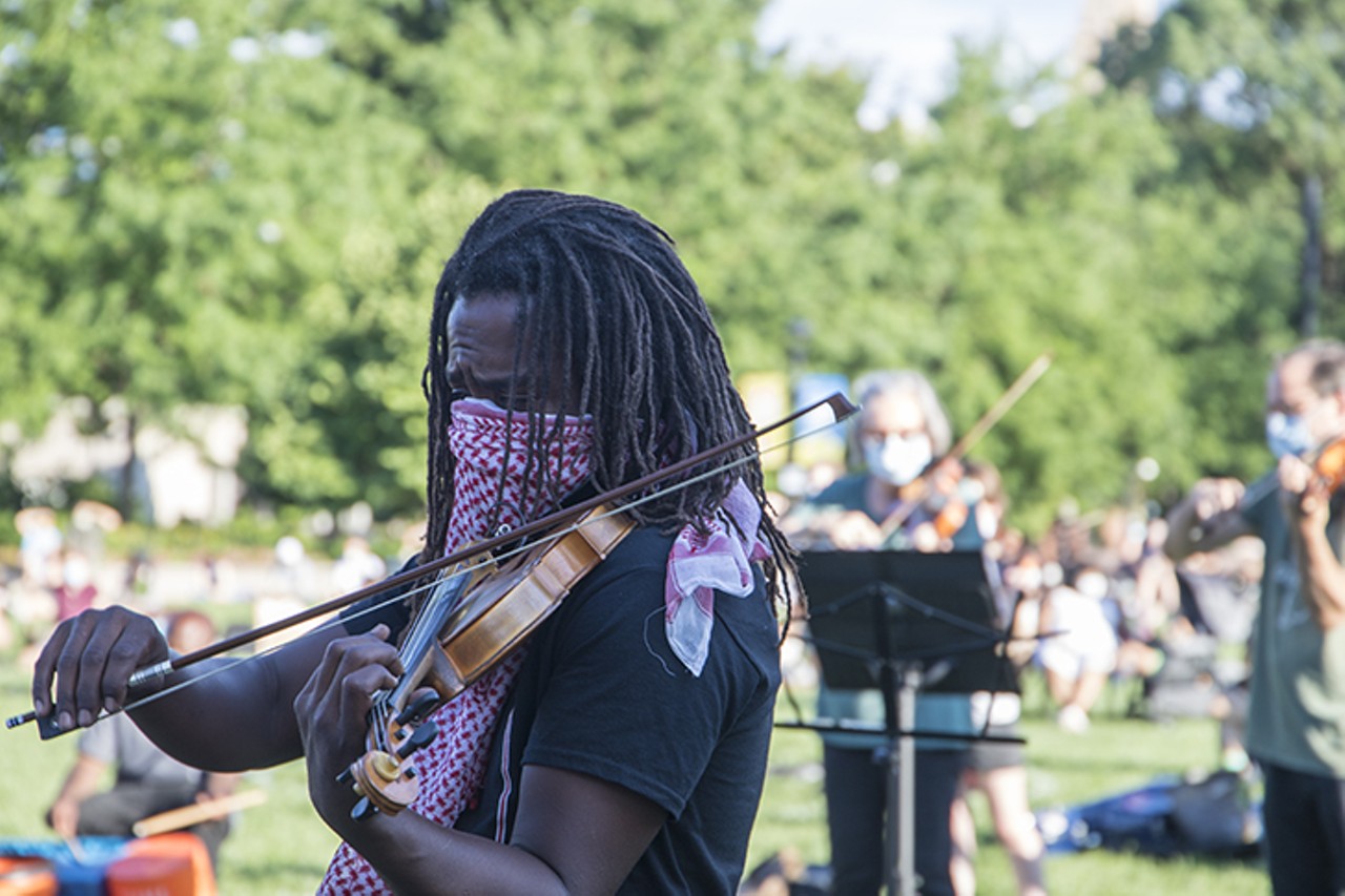 Preston Bell plays violin during a vigil for Elijah McClain July 12 in Washington Park