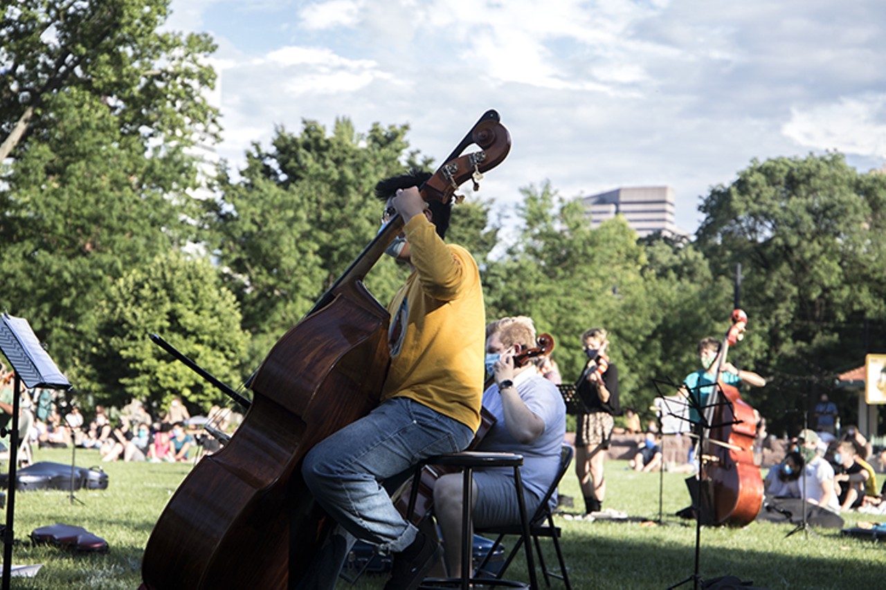 A musician plays during a vigil for Elijah McClain July 12 in Washington Park