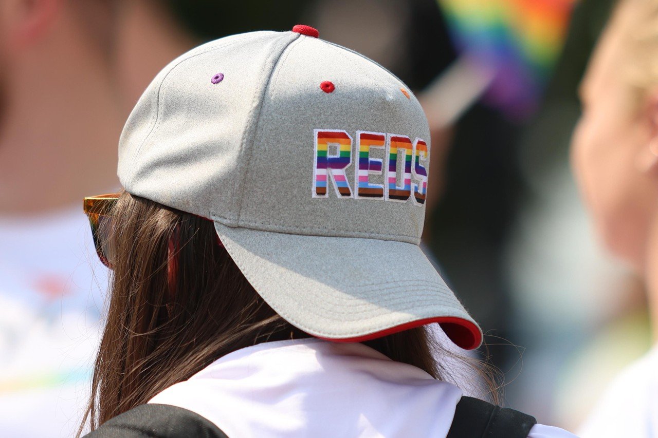 A woman wears a Reds Pride hat at Cincinnati Pride Parade on Saturday, June 22, 2024.