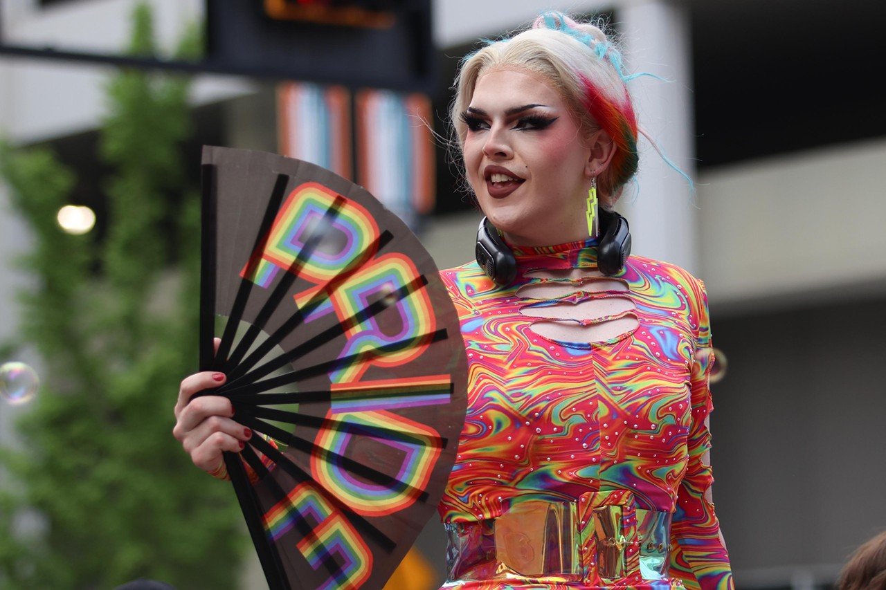 A participant fans herself at the Cincinnati Pride Parade on Saturday, June 22, 2024.