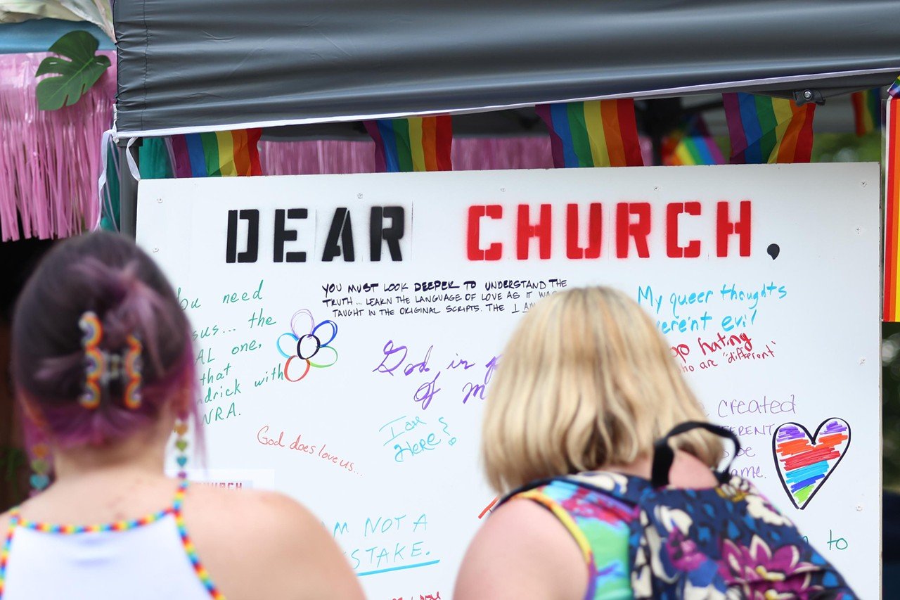 Attendees write on a sign at the Pride festival on Saturday, June 22, 2024.