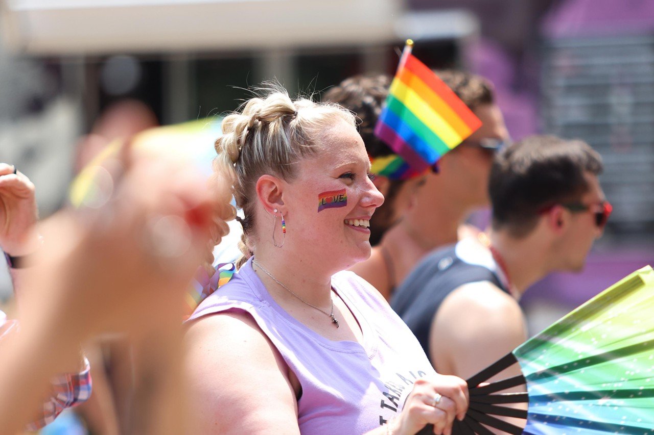 An attendee fans herself while listening to a performer at the Pride festival on Saturday, June 22, 2024.