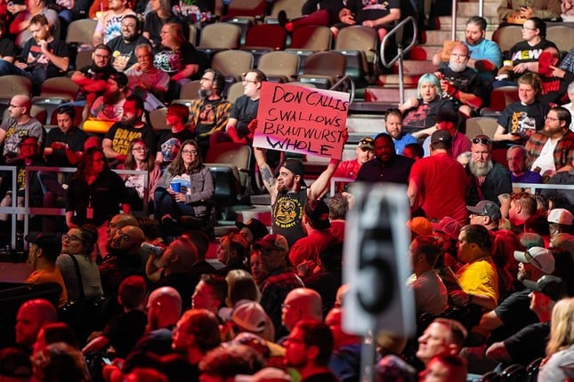 A fan holds his sign high when the Don Callis family makes their entrance | AEW Collision at Truist Arena | April 13, 2024