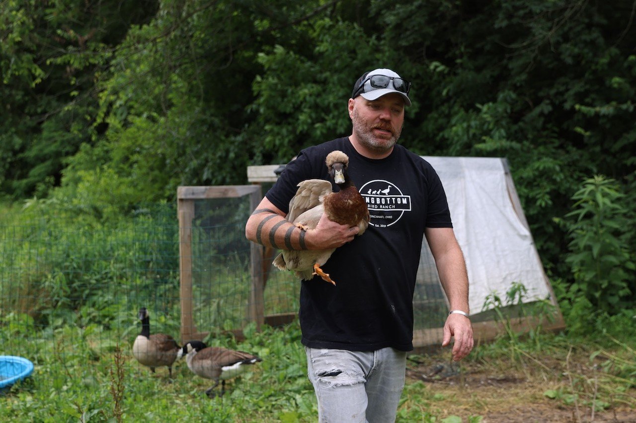 Jimmy Longbottom holds a duck at Longbottom Bird Ranch on Monday, June 10, 2024.