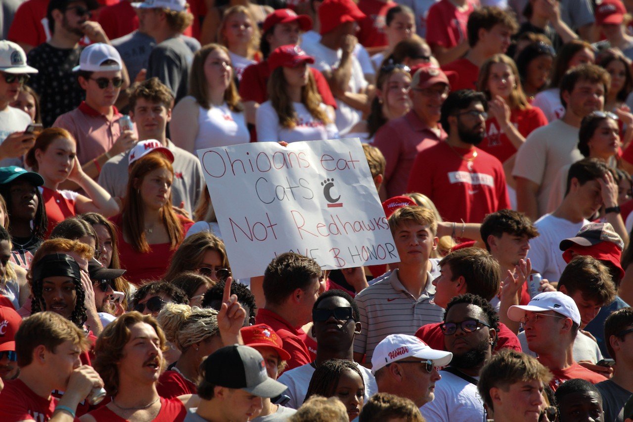 A Miami fan holds up a sign reading, "Ohioans eat Cats not RedHawks."