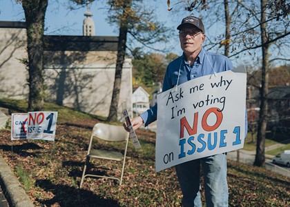 Andy Kluesener campaigns against Issue 1 outside the polling location in Christ the King Church in Mt. Lookout on Nov. 7.